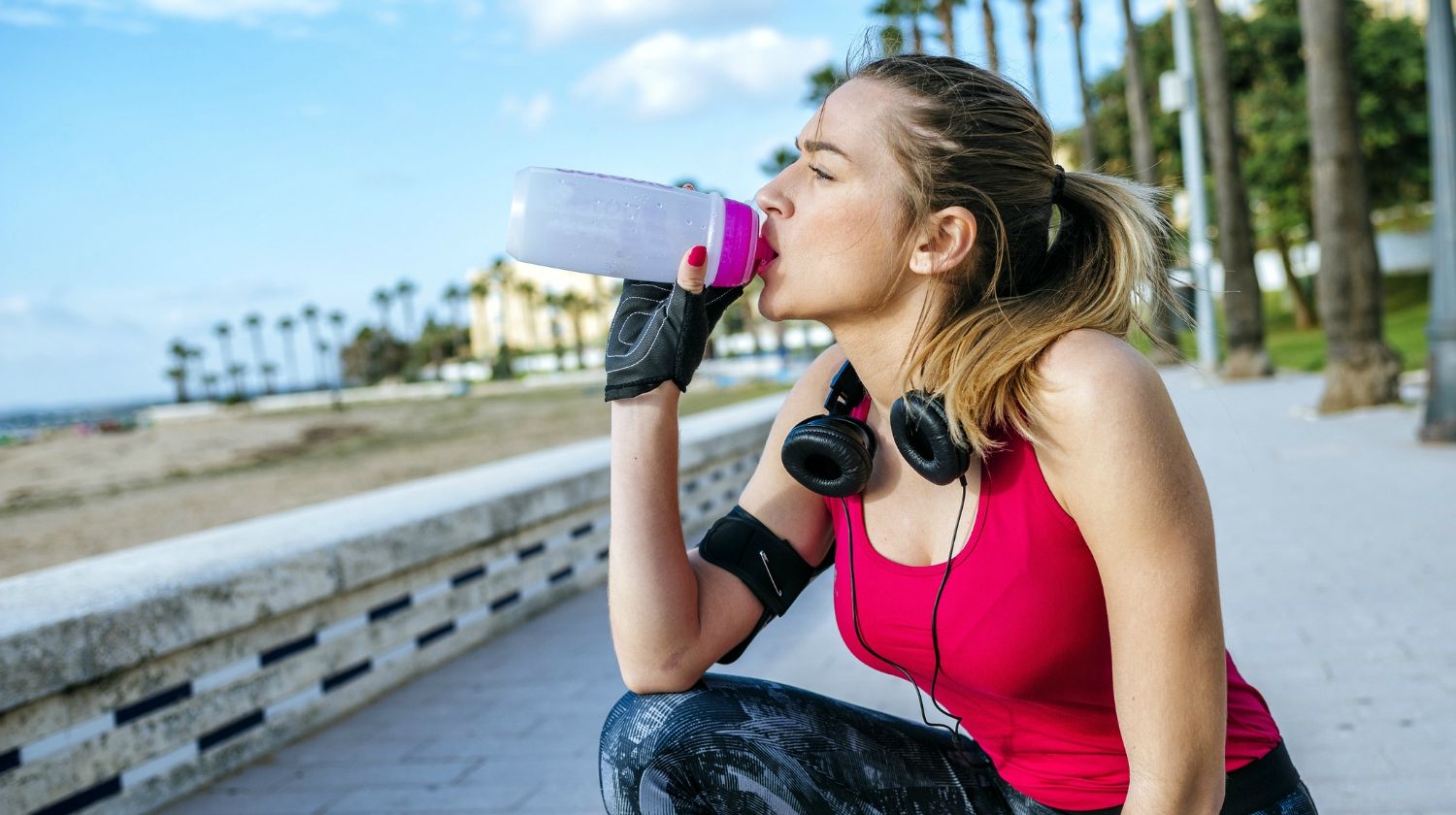 Young blonde sportswoman while drinking water after running | Why Alkaline Water Is Better For Hydration