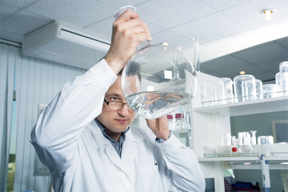 Scientist investigating some water in a beaker